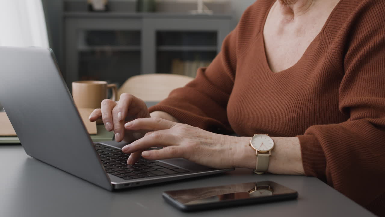 Focused Woman Typewritting At Laptop Sitting At Desk At Home 3