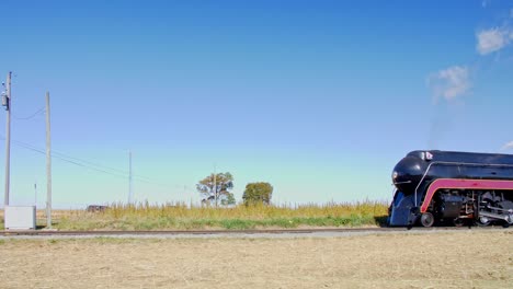 A-View-of-a-Steam-Locomotive-Nearing-am-Intersection-on-a-Sunny-Day-in-Slow-Motion