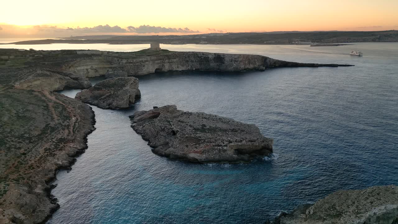Drone Shot Flying Backwards at Sunrise over the Blue Lagoon at Comino Island, Malta