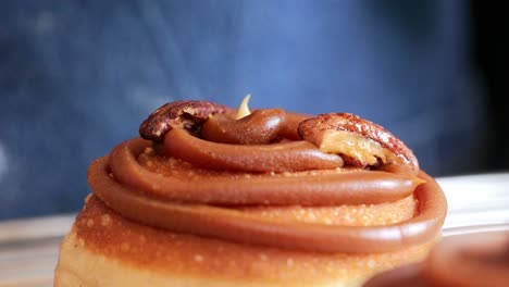 Caramel-donut-being-decorated--side-view