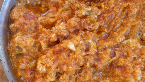 menemen, a turkish breakfast dish made with scrambled eggs, tomatoes, green peppers, and spices