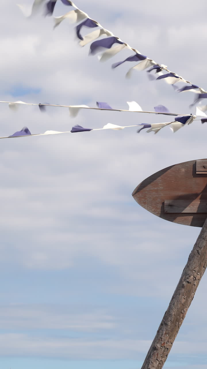 Wooden Sign with Flags in the Wind