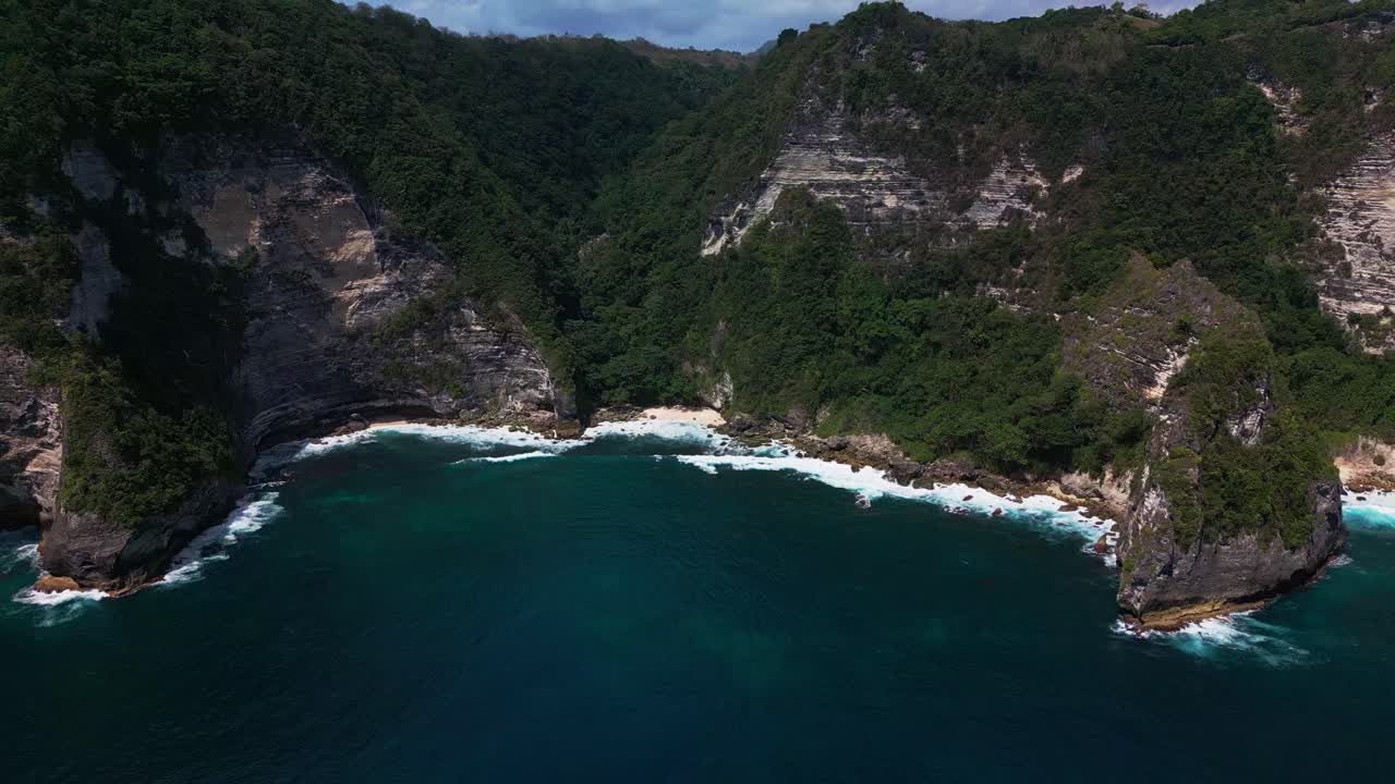 Secret Beach in Bali is surrounded by towering cliffs and lush tropical forest. This hidden paradise offers stunning views of turquoise waters and untouched nature.