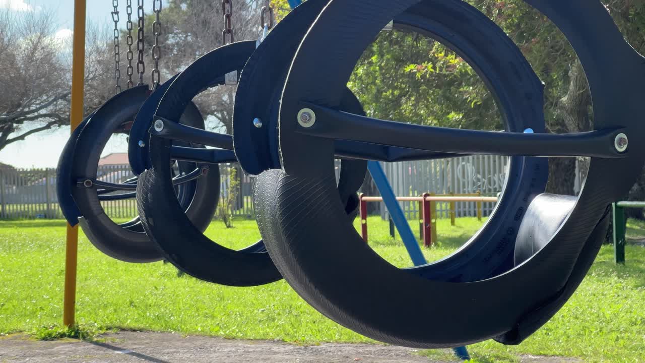 Swings swaying in a playground in Cape Town, South Africa