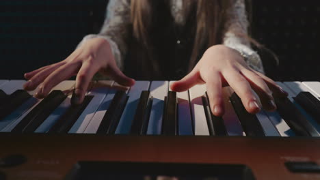 a young girl playing the piano