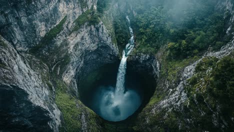 stunning aerial view of a waterfall in a deep canyon