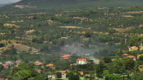 firefighters battling a wildfire in a rural mountainous area