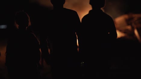 people standing around a bonfire_1