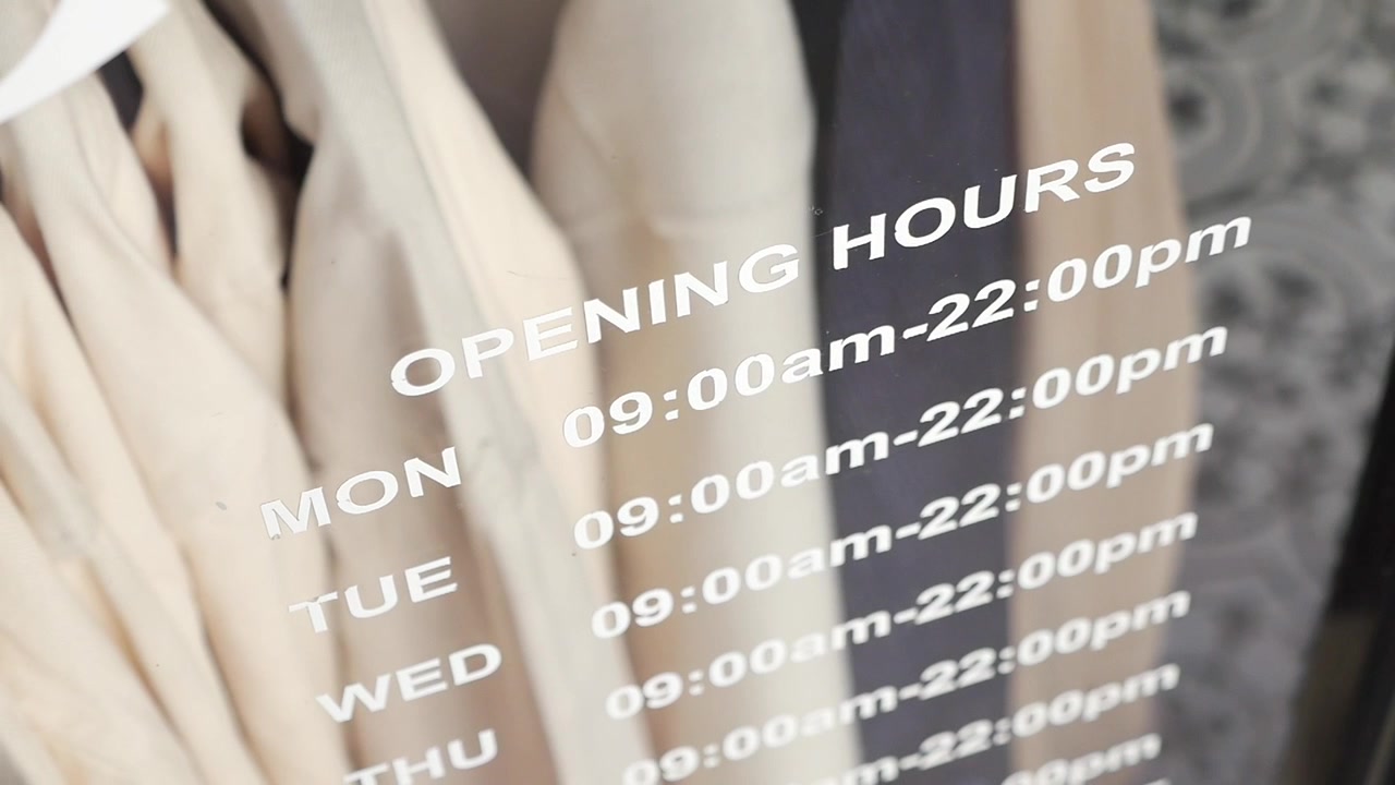 Opening Hours Sign on a Retail Store Window