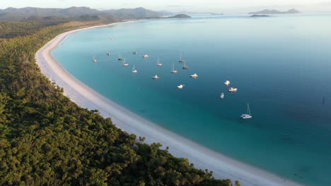 whitehaven beach whitsundays aerial tracking backwards with boats, queensland