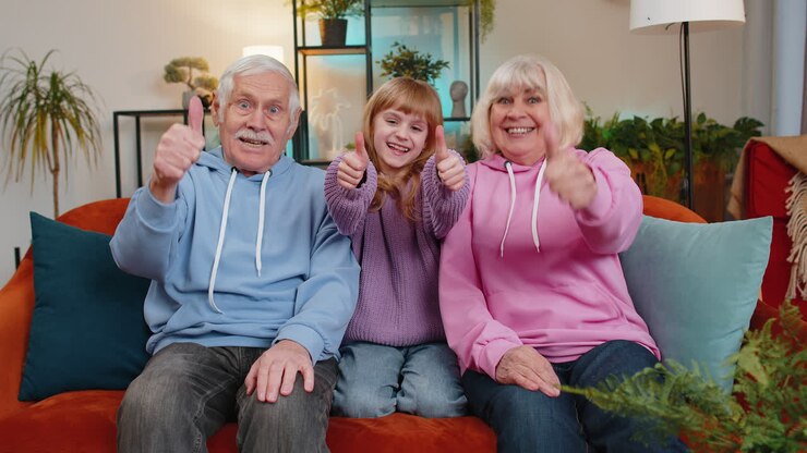 Child girl granddaughter with grandparents showing thumbs up like sign positive positive feedback