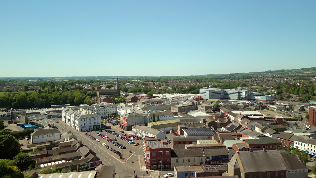 Wide, advancing aerial video of Lisburn, Northern Ireland, UK on a bright and sunny day. Filmed in 4K, 60FPS and with Rec709 Color.