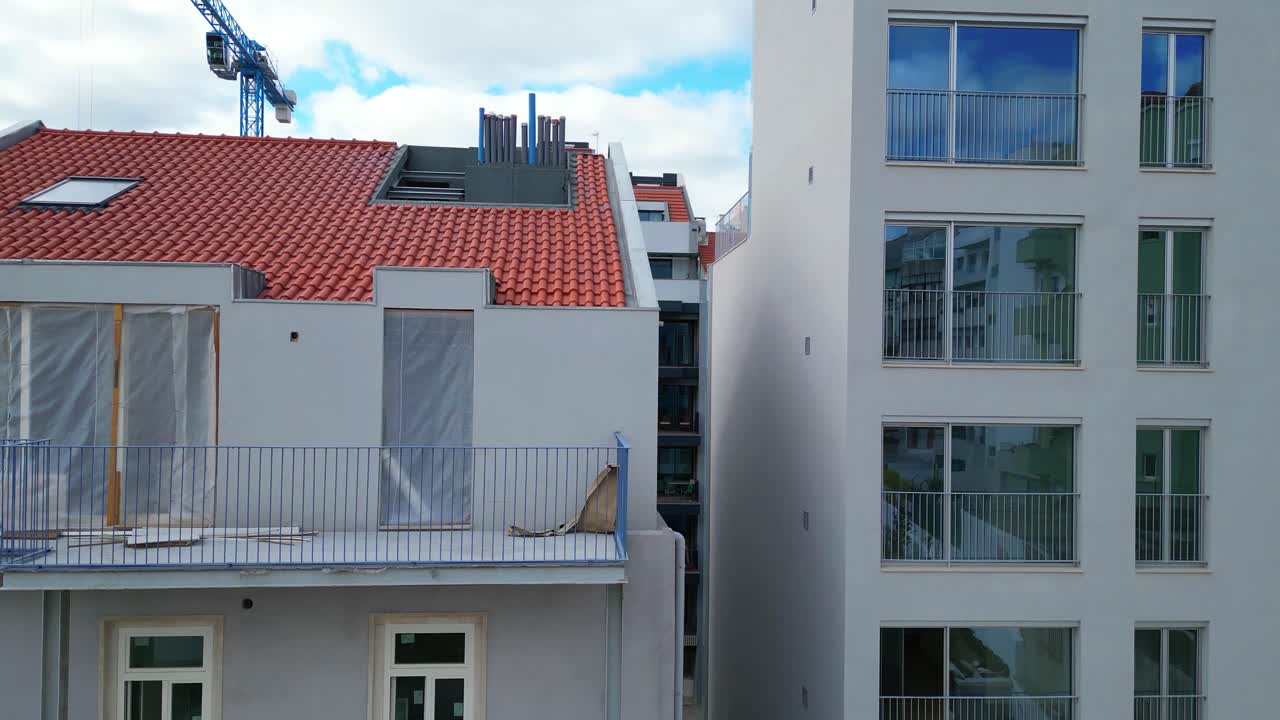 Aerial descending view over a building showing the back be renovated in Lisbon,Portugal