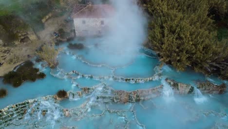 the geothermal hot springs bath and waterfall at saturnia, tuscany italy close to siena and grosseto