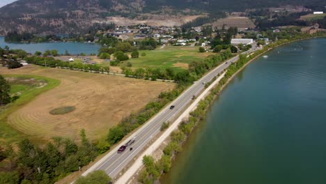 riding a harley davidson chopper motorcycle, on a road trip joyride, along scenic route with lake view