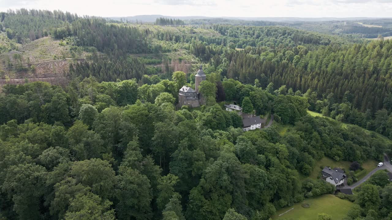 rearward drone shot of Wildenburg Castle in the southeast of the village of Friesenhagen in the North Rhine-Westphalia region of Germany