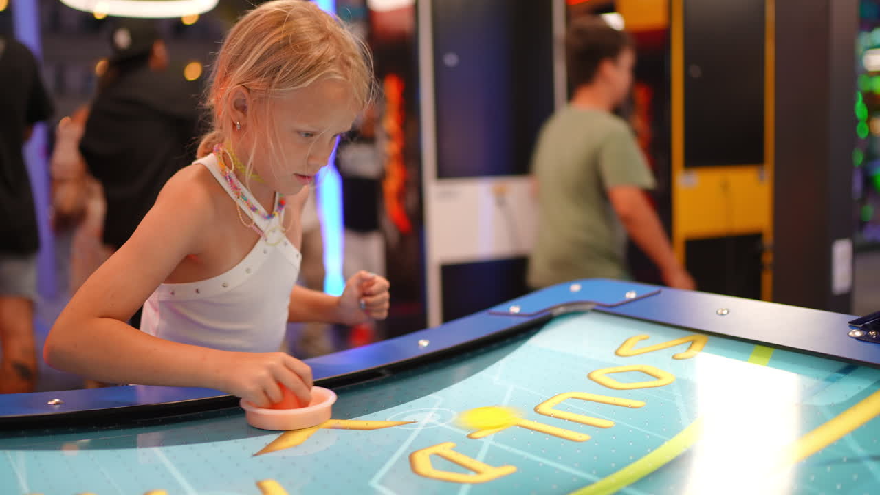 Young girl playing an arcade game
