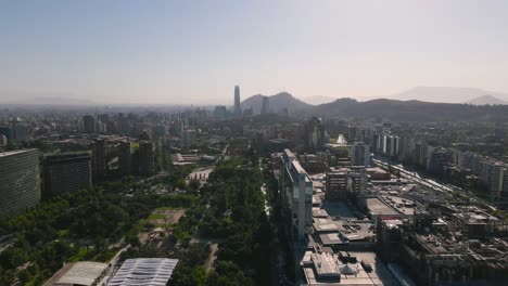 aerial view over kennedy street at santiago de chile with cars in the streets and the skyscrapercity in the background on a sunny day