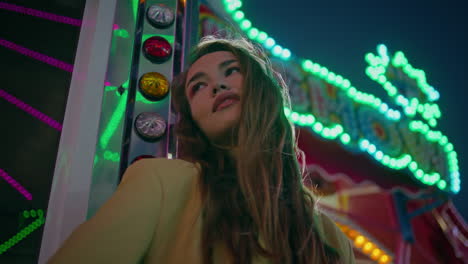 smiling girl posing luna park carousel closeup. dreamy model enjoying night