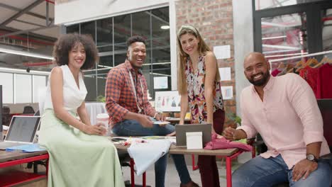 Portrait-of-happy-diverse-male-and-female-designers-in-meeting-at-fashion-studio,-in-slow-motion