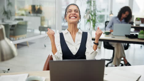 successful businesswoman celebrating at her desk