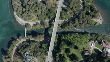 AERIAL---Bridge-over-Correntoso-River,-Neuquen,-Argentina,-top-down-lowering