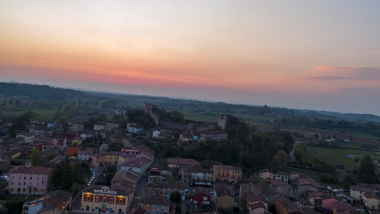 Il villaggio di Monzambano durante un tramonto colorato in Lombardia, Italia. Iperlapse aereo, spazio per il testo