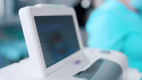 blurred screen of a electrocardiograph close up. equipment for fetal heart rate check up in labor room.