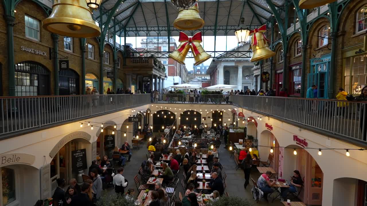 Festive Covent Garden market in London filled with people dining and decorated for Christmas