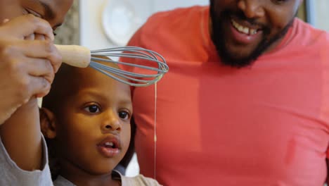 parents and son preparing food in kitchen at home 4k