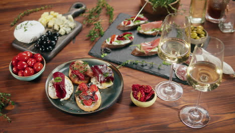 close-up of bruschetta and wine on a wooden table