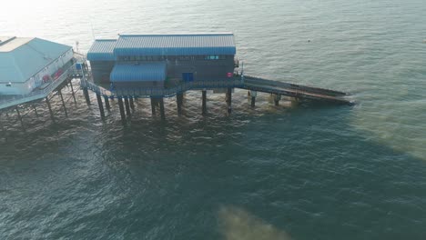 cromer pier lifeboat station on stilts over the sea, captured in aerial view