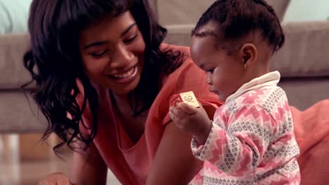 Smiling-mother-playing-with-her-daughter