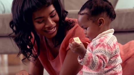 smiling mother playing with her daughter