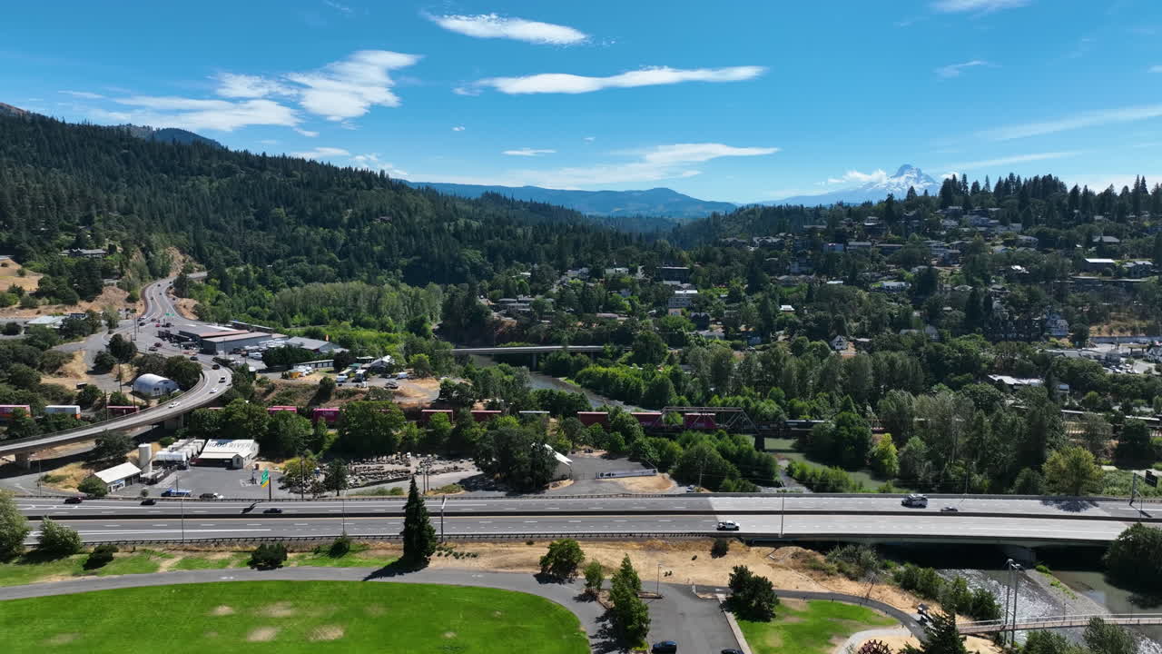 Aerial view of a train and traffic in the Hood river town, in sunny Oregon, USA