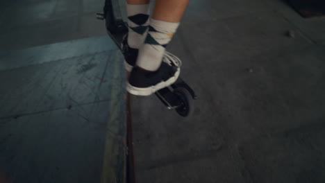 Active-scooter-rider-performing-tricks-during-freestyle-session-at-skate-park.