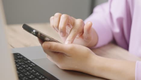 a young businessman is taking a video conference and touchscreen with customers via a smart phone connected to the internet.