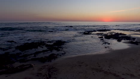 4k pull aways aerial shot of a beautiful sea coast at dusk