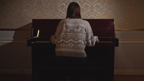 person playing piano in a luxurious room