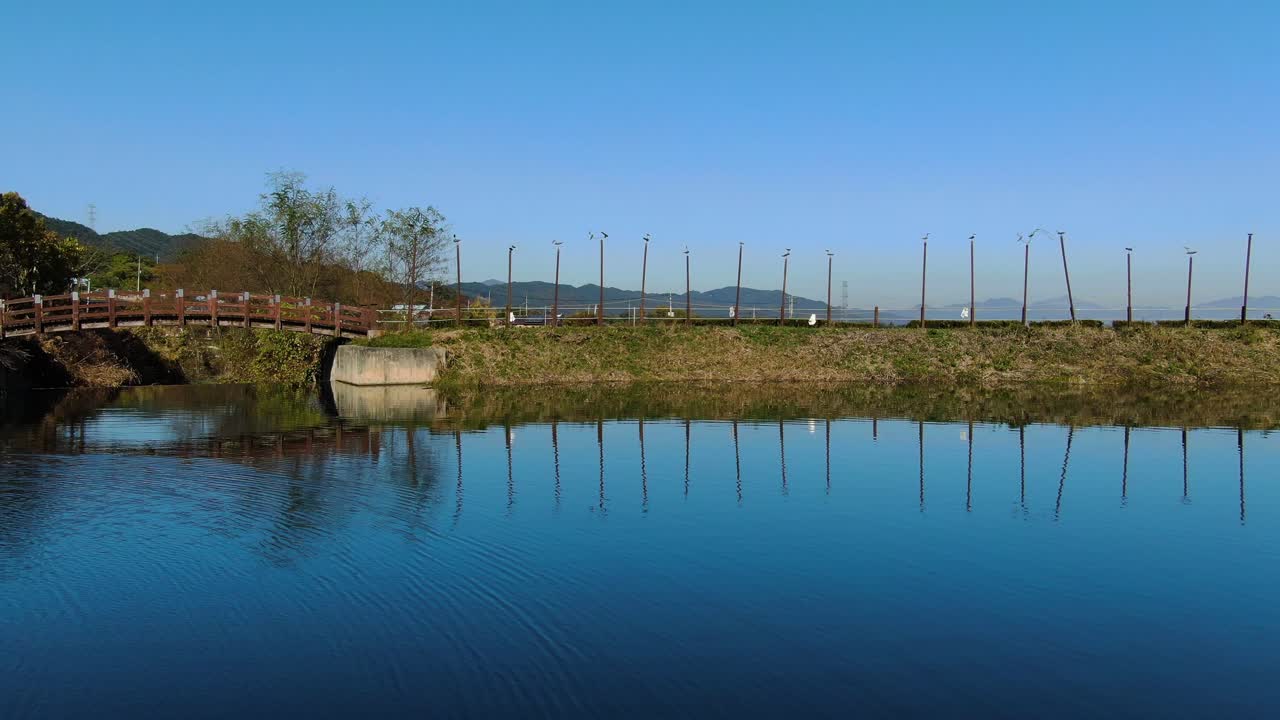 the blue sky reflected in the tranquil reservoir.