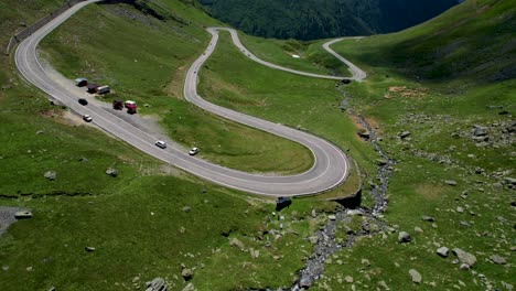 Beautiful-Aerial-View-Of-Transfagarasan-Mountain-Road-Crossing-the-Carpathian-Mountains-in-Romania,-Aerial-View-Of-A-Beautiful-Mountain-Range-With-High-Peaks,-Thick-Fluffy-Clouds