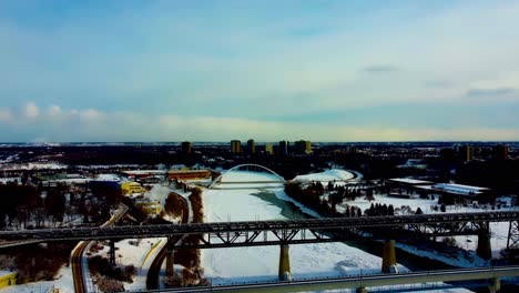 Winter-afternoon-aerial-flyover-snow-covered-North-Saskatchewan-River-Victoria-Kinsmen-Park-Briges-of-Dudley-B-Menzies-for-public-transit-rail-high-level-with-streetcar-track-modern-walter-dale-blu2-4