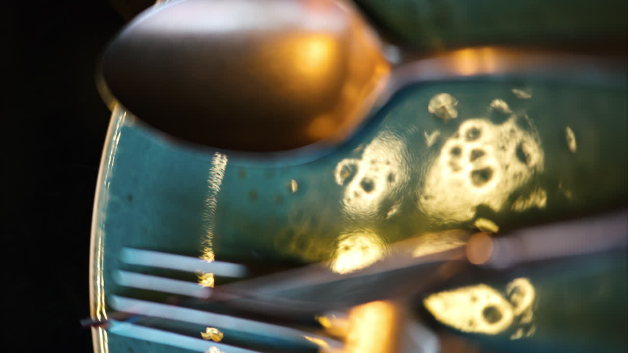 Stainless steel food cutlery on a ceramic plate