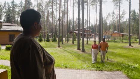 happy couple visiting man's mom and then they embracing each other outside home