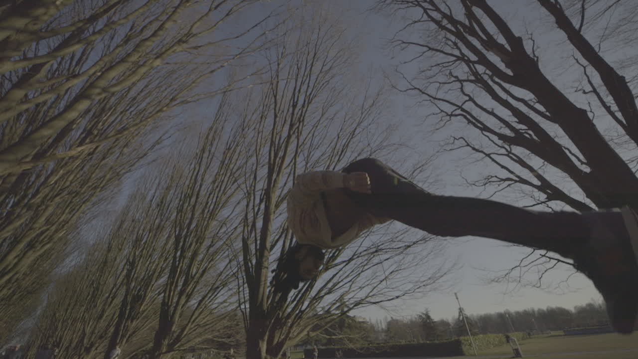 Person performing parkour in a park