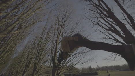 person performing parkour in a park