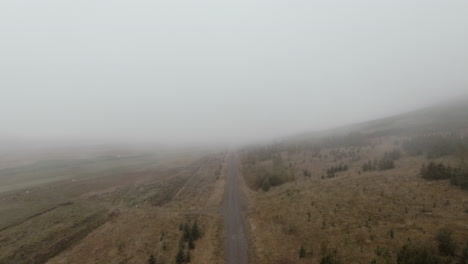 footage above gravel road in foggy icelandic countryside