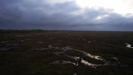 The-sky-reflects-on-the-surface-of-countless-meanders-and-mudflats-in-Slufter-Vallei-in-Texel-National-Park,-Netherlands-Mudflats-stretch-to-the-horizon