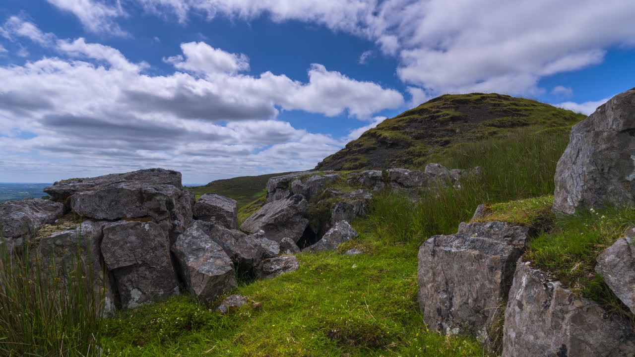 Time lapse of rural landscape with rocks in the foreground in grass hillside on a spring sunny day in Arigna mountains in county Leitrim in Ireland