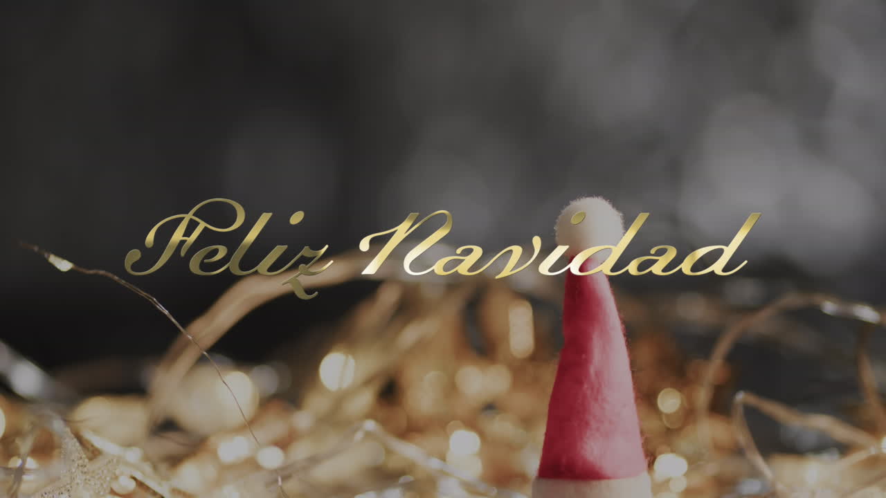 Feliz navidad text over christmas hat and decorations on grey background